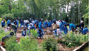 笹川邸ガーデンにて味方中学校の生徒が花植えをしている写真