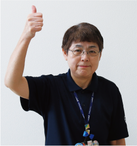 手話通訳者・鈴木さんが親指を立てて高く上げている写真