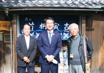 「魚や片桐寅吉・港茶屋」（上大川前通12）前。左から同店社長藤田普さん、中原市長、新潟シティガイド渡辺博さん